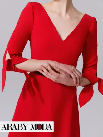 Close-up on the tied sleeves of a red Carolina Herrera dress