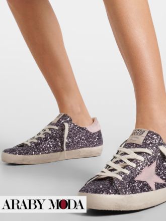 Golden Goose sneakers with silver glitter and pink sheen exude a youthful and vibrant spirit