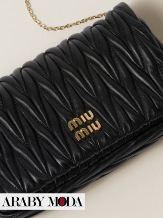 Black Miu Miu leather clutch completes a look of extreme luxury and beauty