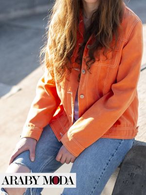 Orange jeans jacket with jeans to create a bold look