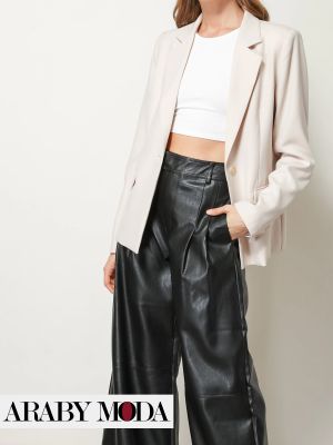 Black wide leather pants with an off-white blazer for a modern look