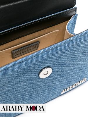 Picture of Jacquemus Le Chiquito Moyen denim bag shows the size of the bag's pocket