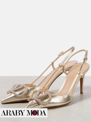 Gold Valentino heels decorated with crystals to complete the luxurious Ramadan outfit