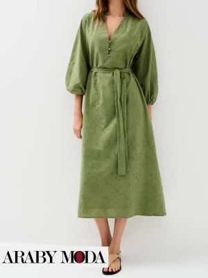Green dress in light fabric shows the femininity and softness of millennial woman
