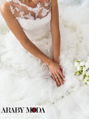 White winter wedding dress with ruffled layers and embroidered from the top