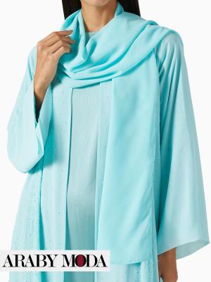 Amazing harmony between the abaya, the shaila, and the blue dress