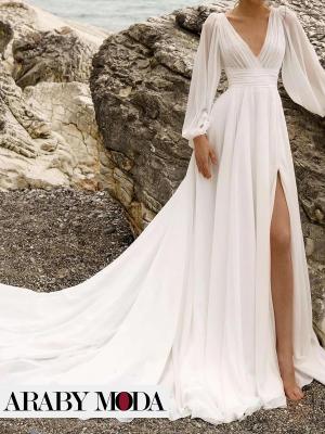 Long-sleeved chiffon wedding dress with an empire waist and a long tail